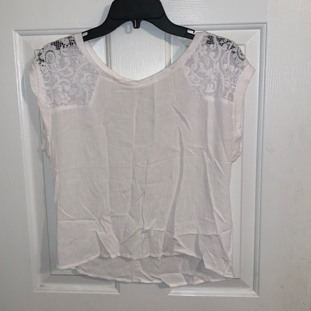 White top with lace material on shoulders